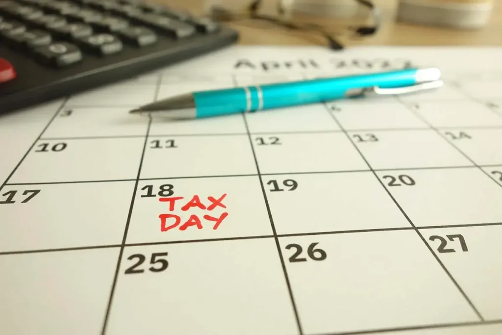 A desk calendar with one day labeled tax day in red ink.