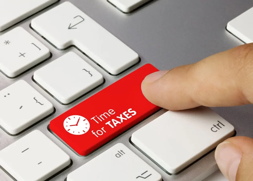 Red button on a keyboard labeled time for taxes.