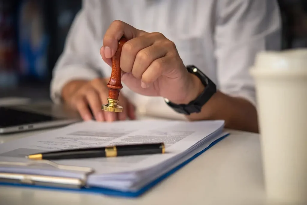 Accountant stamping paperwork.