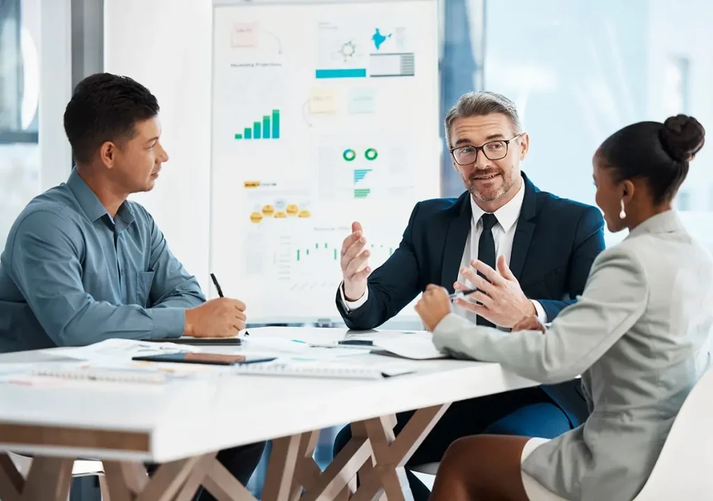 Three people in a business meeting.