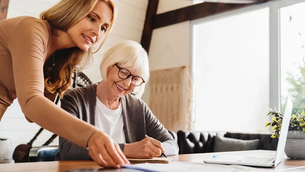 Woman looking over tax documents with a senior.