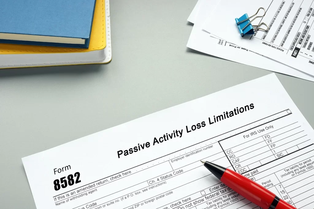 Close up of tax form 8582 for passive activity loss limitation with pen.