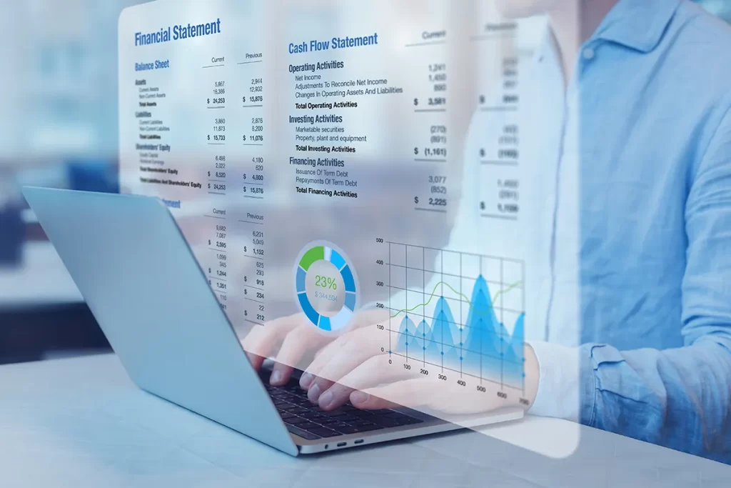 Accountant typing on computer with image of a financial statement projecting above the keyboard.